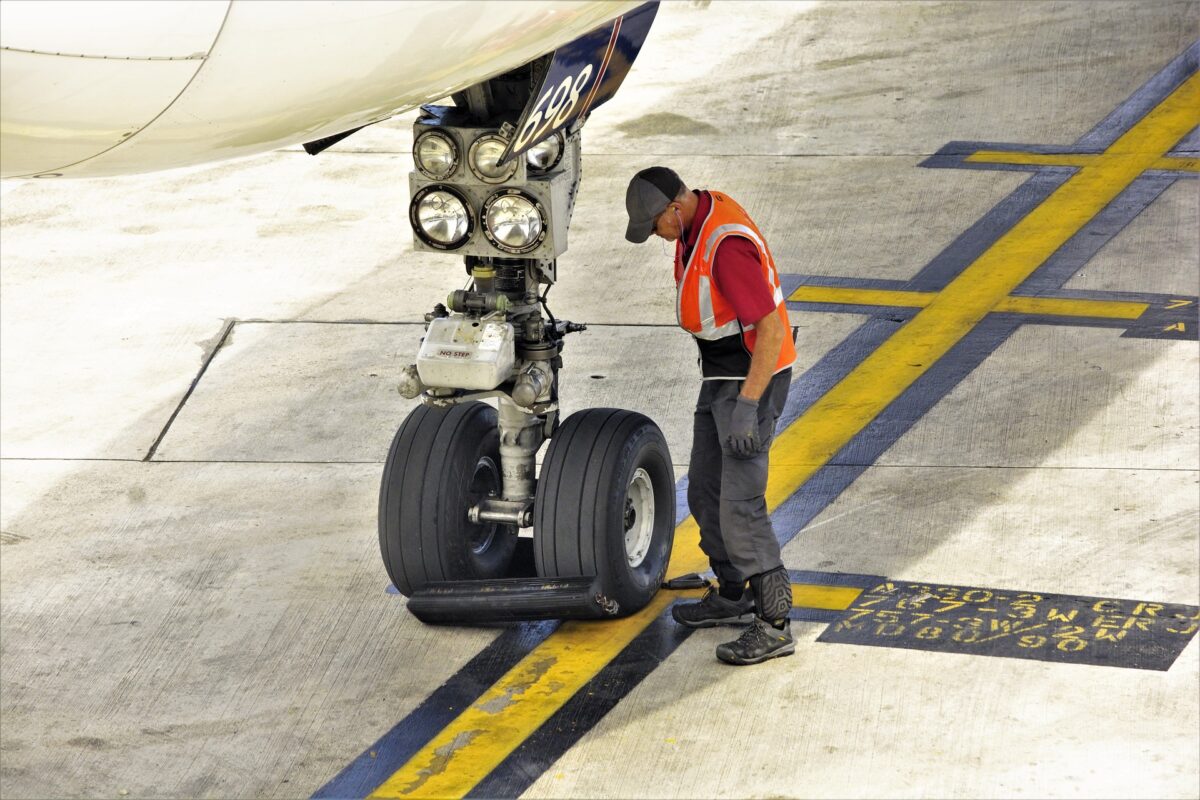 aircraft landing gear and worker